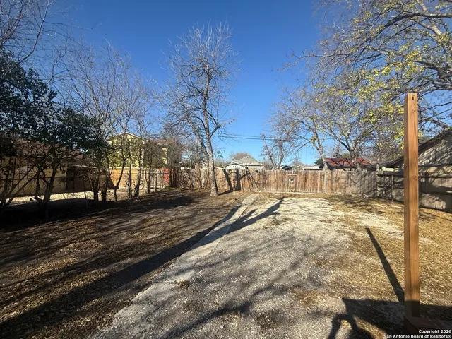 a view of a yard with snow on the road