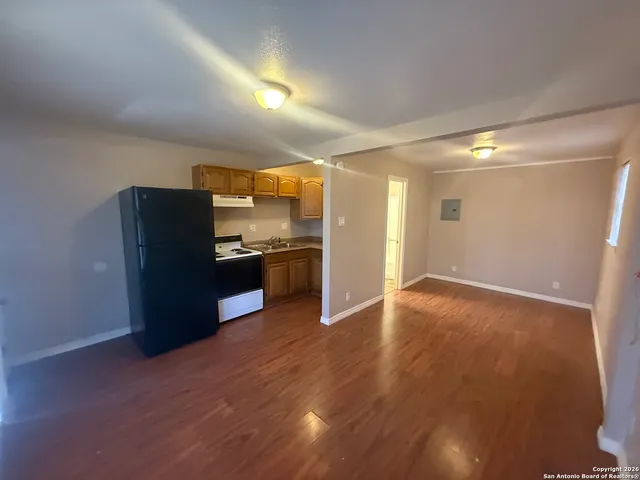 a view of kitchen with kitchen island and wooden floor