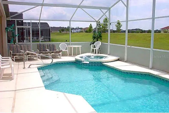 a view of a backyard with sitting area