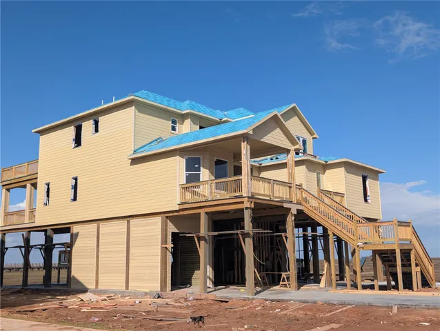 a living room with furniture and a view of kitchen