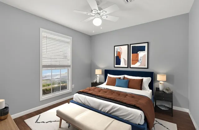 a bedroom with a large bed and two window