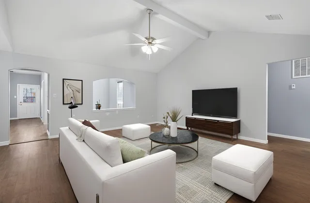 a living room with furniture and a flat screen tv
