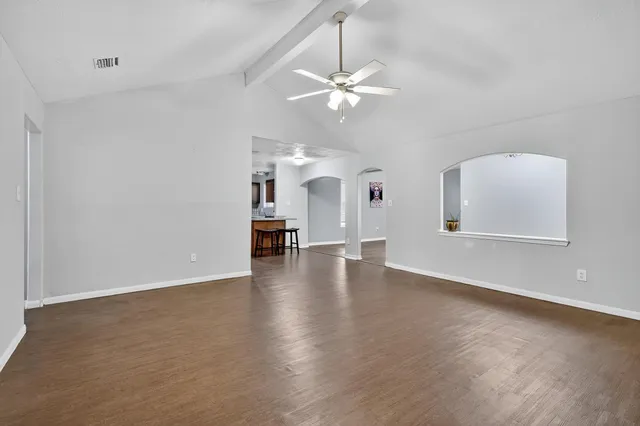 a view of a livingroom with a furniture chandelier fan