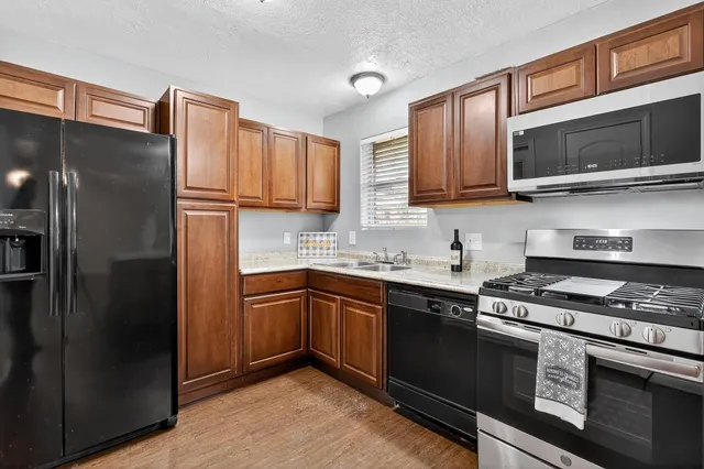 a kitchen with a sink stove and refrigerator