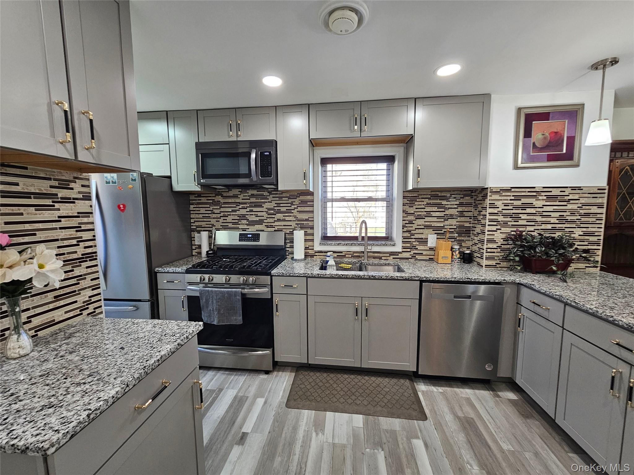 88 Innis Avenue Poughkeepsie, NY 12601 - Photo 12 of 33 a kitchen with stainless steel appliances granite countertop a stove sink and cabinets