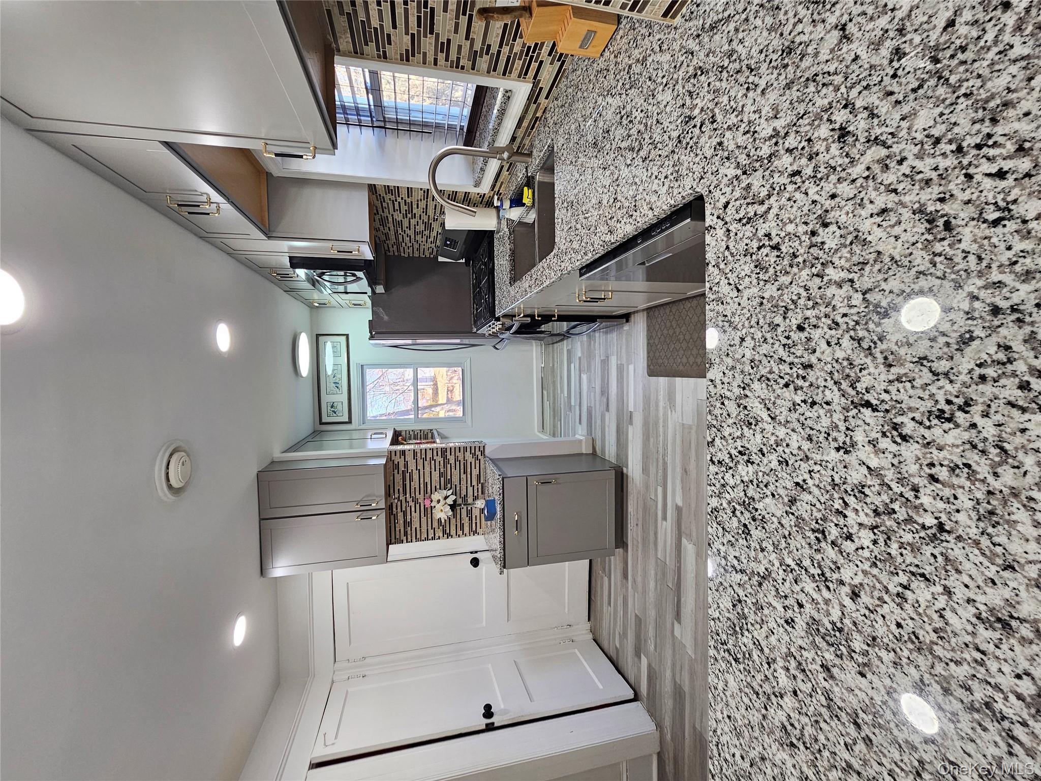 88 Innis Avenue Poughkeepsie, NY 12601 - Photo 13 of 33 Kitchen featuring gray cabinets, tasteful backsplash, light stone counters, stainless steel appliances, and recessed lighting