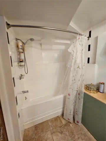 a bathroom with a shower and a tub