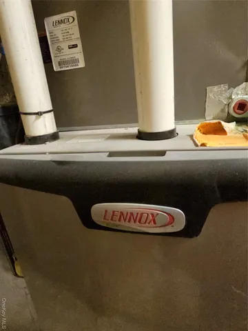 a living room with chairs and appliances