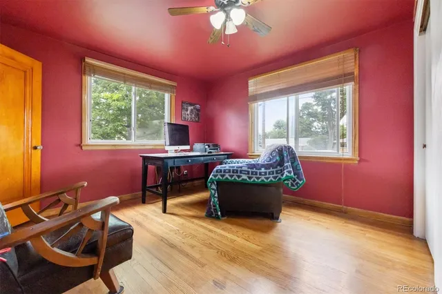 a view of a workspace with furniture and a window