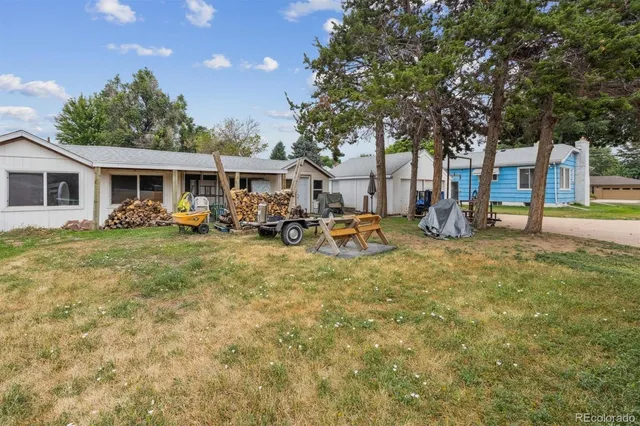 a backyard of a house with garden and outdoor seating