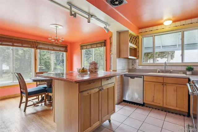 a kitchen with a sink dining table and chairs