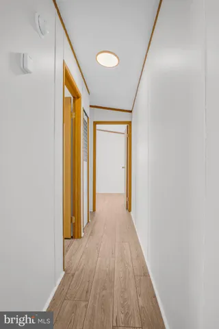 a view of a hallway with wooden floor