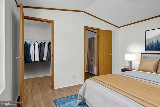 a bedroom with a bed and a painting on the wall