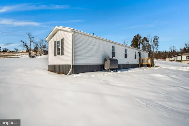 a view of a house with a snow in the background