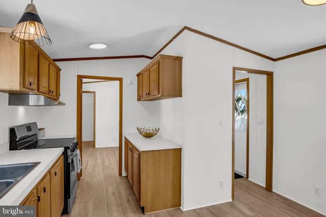 a kitchen with a refrigerator and a stove top oven