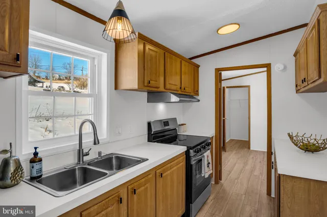 a kitchen with a sink cabinets and a stove