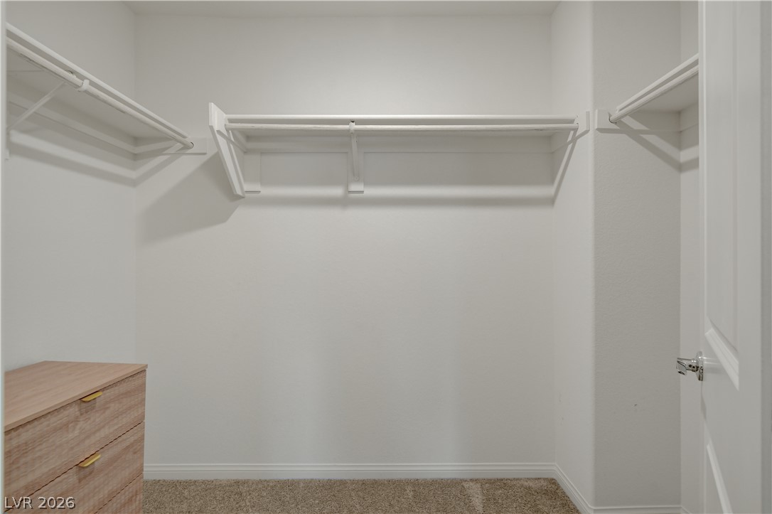 6924 Spicy Merlot Street North Las Vegas, NV 89086 - Photo 33 of 83 Ample hanging space and shelving create an organized wardrobe in this tidy closet.