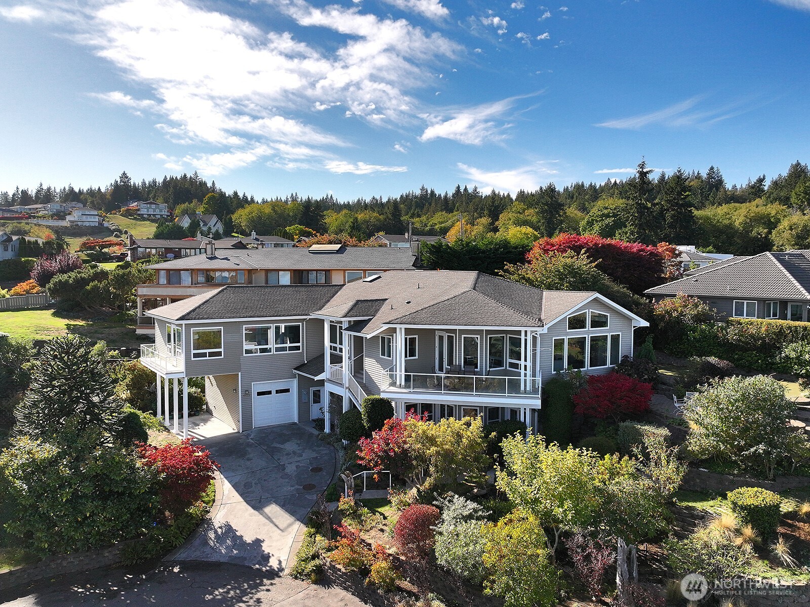 4694 Wrightsman Place Clinton, WA 98236 - Photo 1 of 38 an aerial view of a house with a garden and balcony