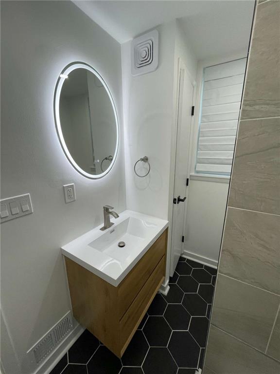 107 Shoup Street, Unit 2 Pittsburgh, PA 15209 - Photo 16 of 40 a bathroom with a sink a toilet and a mirror