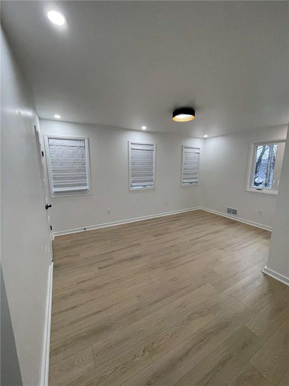 107 Shoup Street, Unit 2 Pittsburgh, PA 15209 - Photo 19 of 40 an empty room with wooden floor and windows