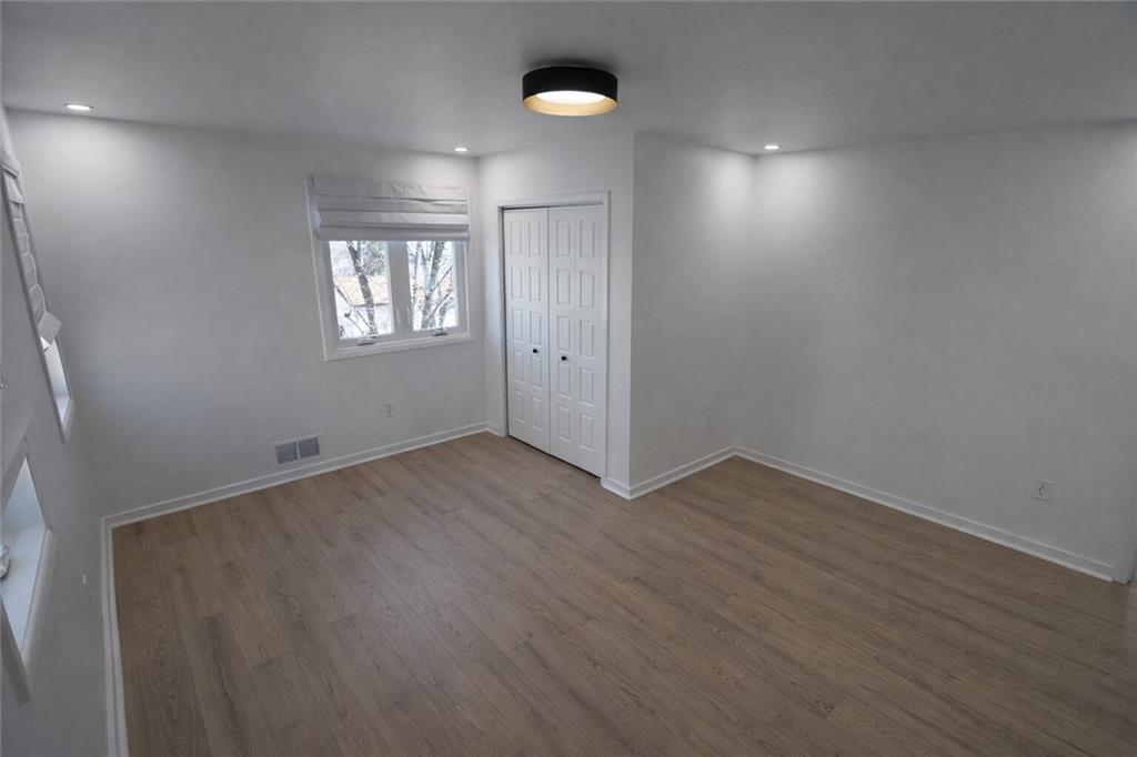 107 Shoup Street, Unit 2 Pittsburgh, PA 15209 - Photo 21 of 40 an empty room with wooden floor and windows