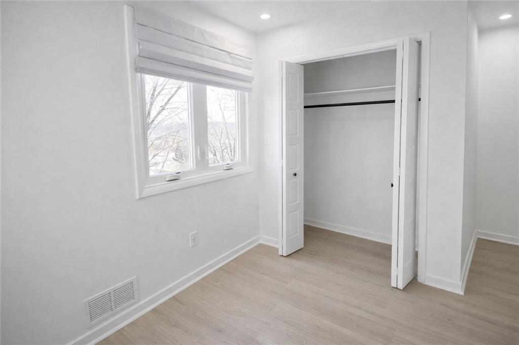 107 Shoup Street, Unit 2 Pittsburgh, PA 15209 - Photo 23 of 40 a view of an empty room with wooden floor and a window