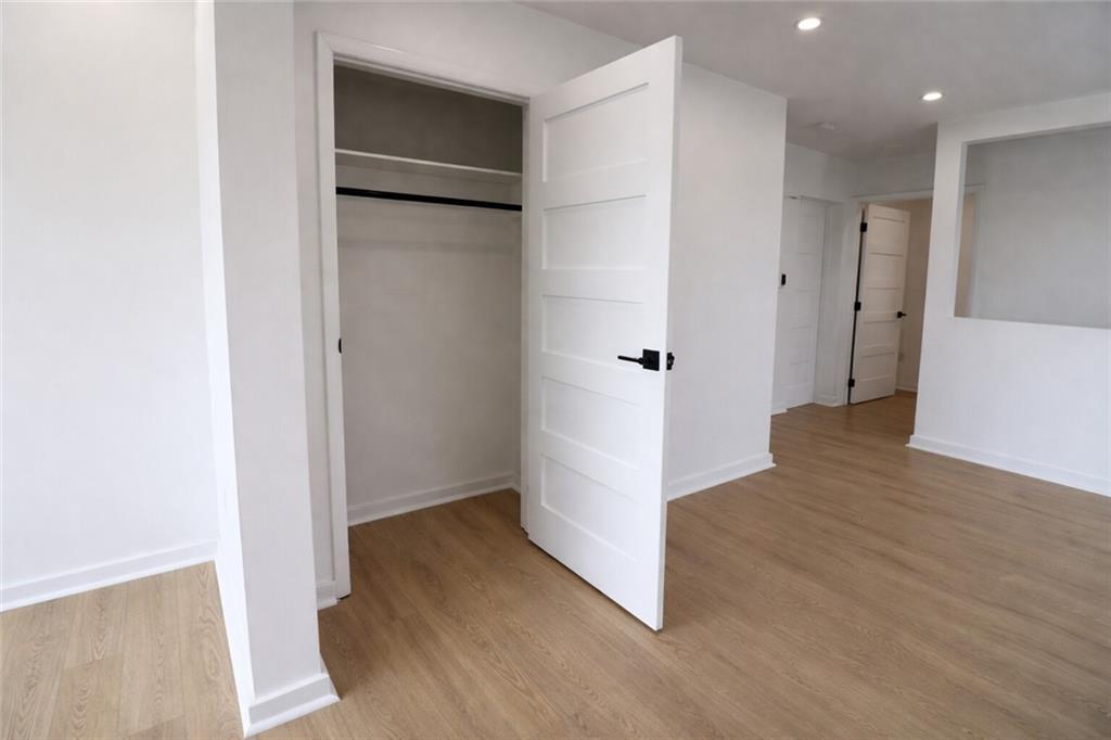 107 Shoup Street, Unit 2 Pittsburgh, PA 15209 - Photo 25 of 40 a view of an empty room with wooden floor and a bathroom