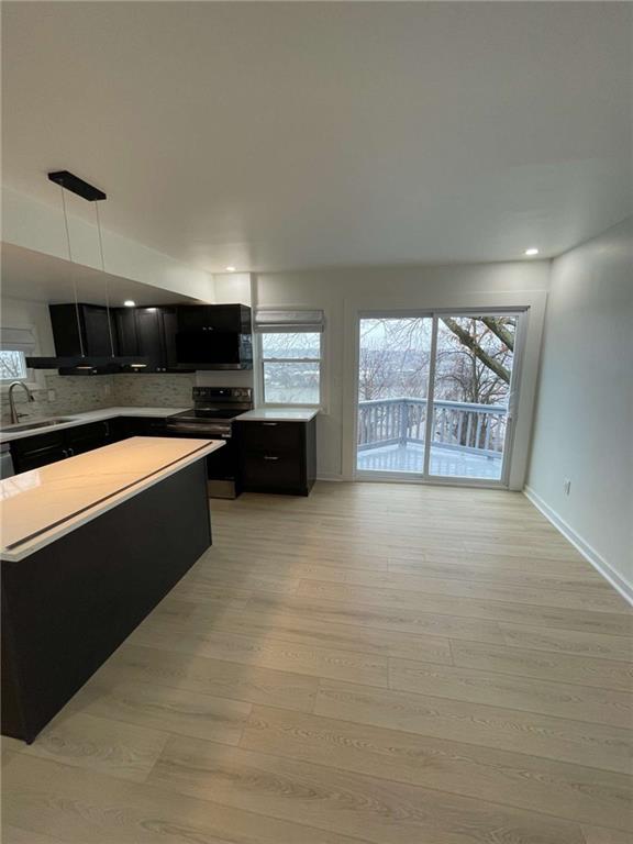 107 Shoup Street, Unit 2 Pittsburgh, PA 15209 - Photo 27 of 40 a large kitchen with stainless steel appliances granite countertop a stove a sink and a microwave