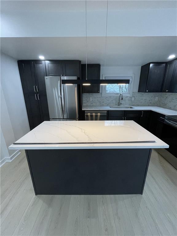 107 Shoup Street, Unit 2 Pittsburgh, PA 15209 - Photo 31 of 40 a kitchen with a wooden floor and stainless steel appliances