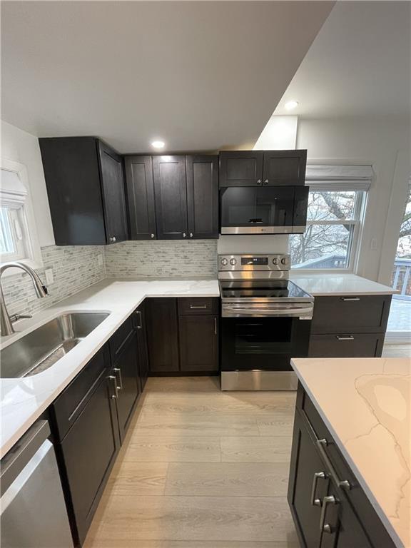 107 Shoup Street, Unit 2 Pittsburgh, PA 15209 - Photo 33 of 40 a kitchen with a sink and a stove top oven with wooden floor