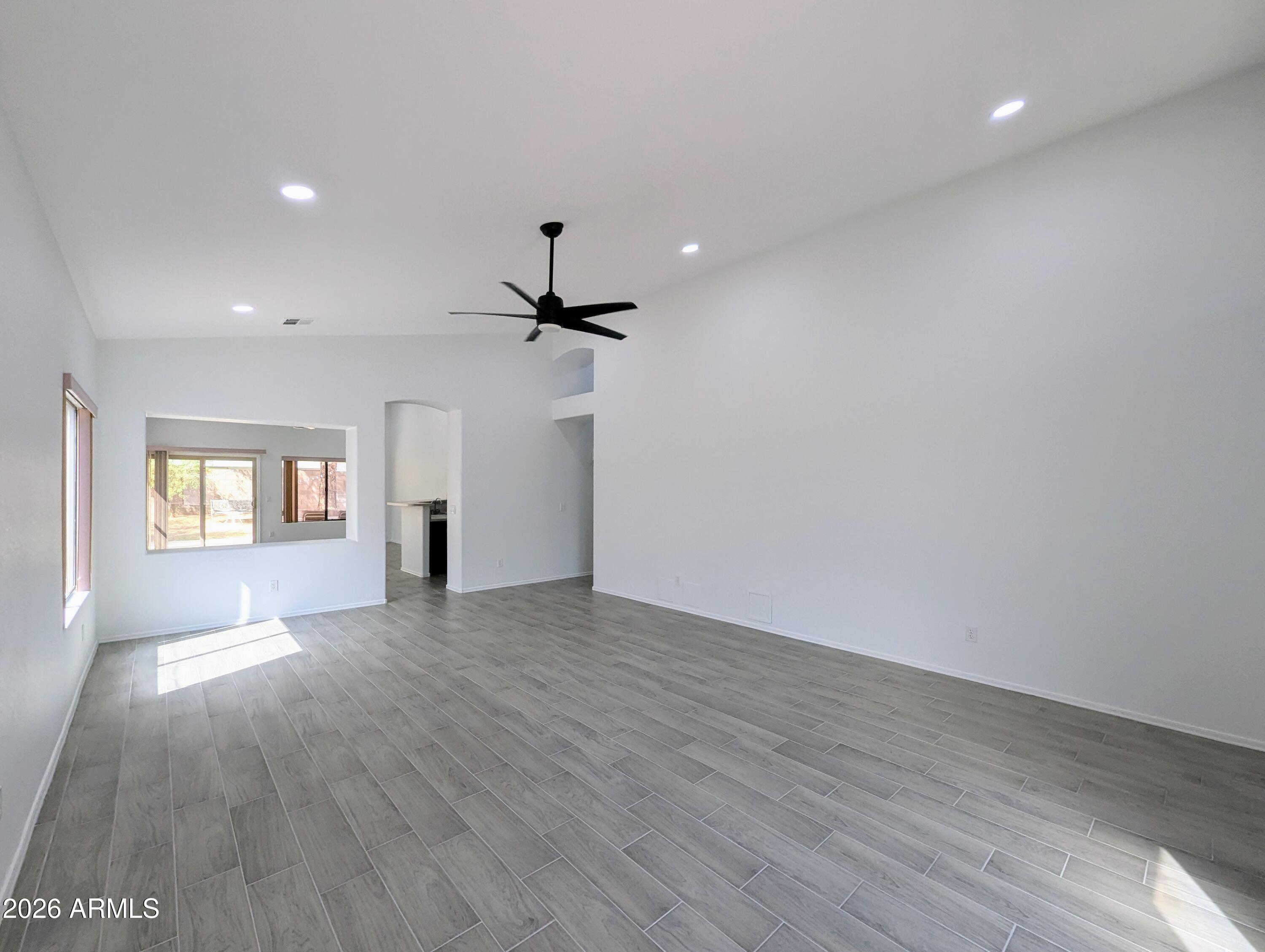 5424 West Wagoner Road Glendale, AZ 85308 - Photo 6 of 37 a view of empty room with wooden floor and fan