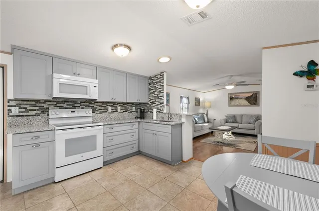 an aerial view of a house with swimming pool and outdoor seating