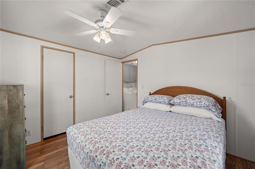 24437 Harbor View Road, Unit 114 Punta Gorda, FL 33980 - Photo 22 of 55 a bedroom with a bed and a chandelier