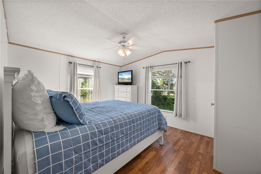 24437 Harbor View Road, Unit 114 Punta Gorda, FL 33980 - Photo 27 of 56 a bed sitting in a bedroom next to a window