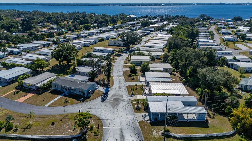24437 Harbor View Road, Unit 114 Punta Gorda, FL 33980 - Photo 36 of 55 an aerial view of multiple houses with yard