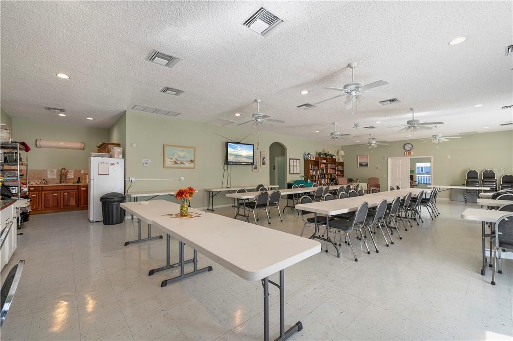 24437 Harbor View Road, Unit 114 Punta Gorda, FL 33980 - Photo 54 of 56 a room with lots of furniture and a chandelier