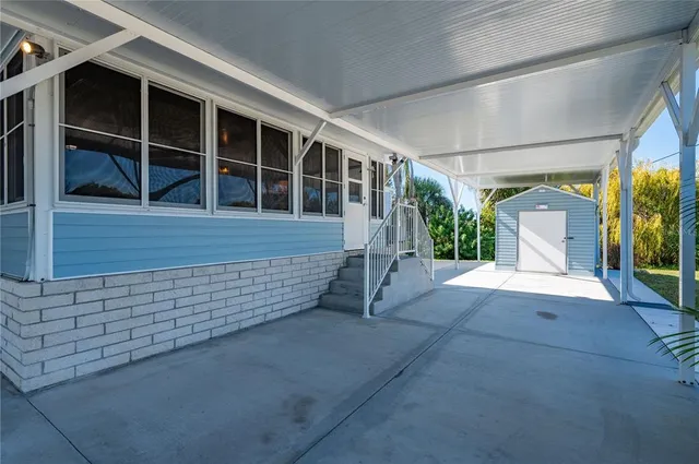 a kitchen with stainless steel appliances a refrigerator a stove a sink and white cabinets