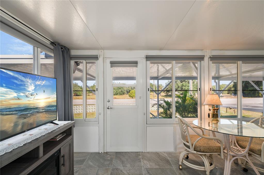 24437 Harbor View Road, Unit 114 Punta Gorda, FL 33980 - Photo 6 of 55 a living room with furniture and a flat screen tv