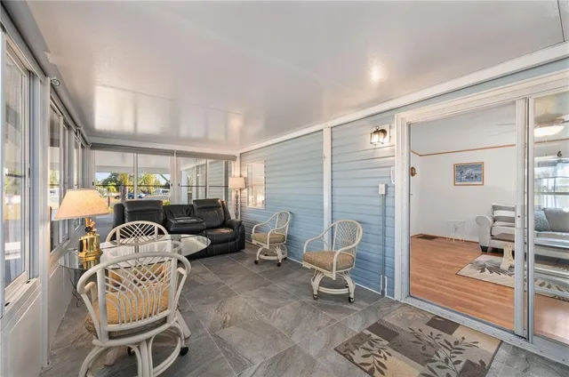 a kitchen with a sink and chairs