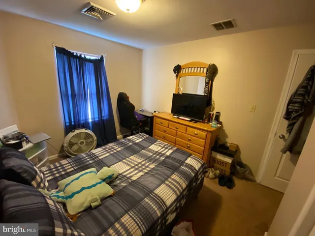 a bed sitting in a room next to a window