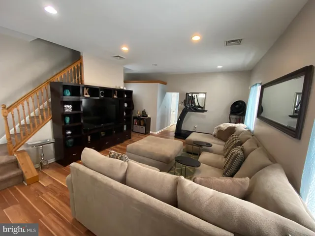 a kitchen with stainless steel appliances granite countertop a refrigerator a sink a stove a washer dryer and a refrigerator