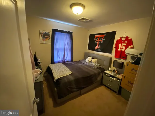 a bedroom with a bed and a mirror