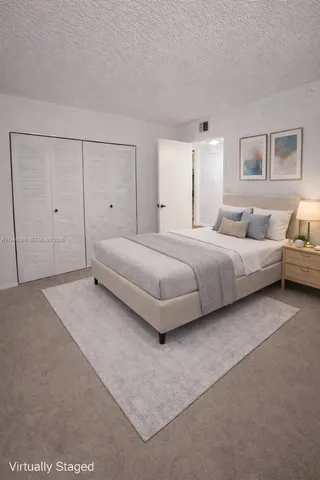 a bedroom with a bed and a night stand