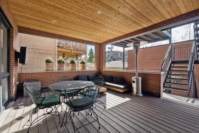 a balcony with furniture and wooden floor