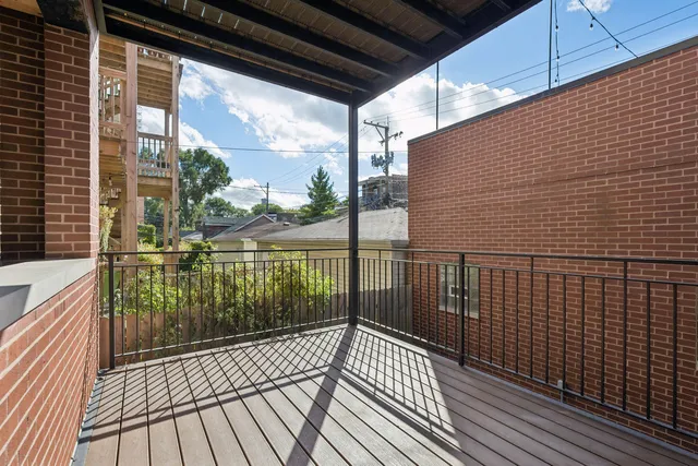 a view of a balcony with wooden floor