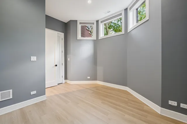 a view of an empty room with window and closet