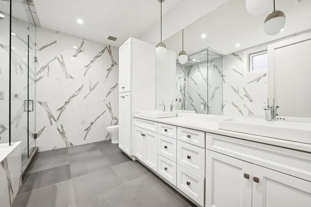 a bathroom with a double vanity sink and mirror