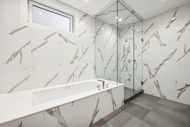 a bathroom with a bathtub and shower