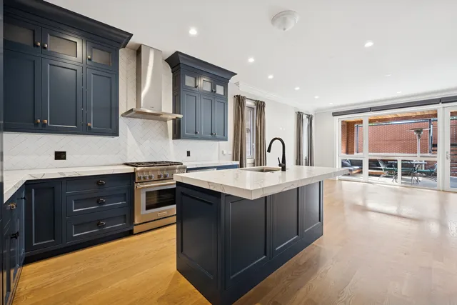 a kitchen with stainless steel appliances granite countertop a sink stove and cabinets