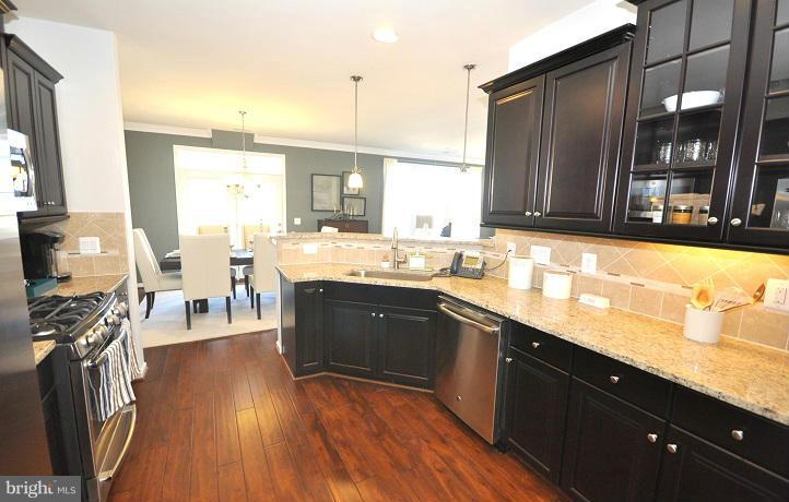 42590 Sunset Ridge Square Ashburn, VA 20148 - Photo 2 of 13 a spacious kitchen with stainless steel appliances granite countertop a sink counter space and a large window